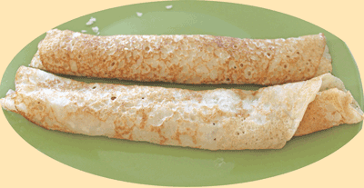 Appau made with a batter that contains yeast. It makes a delicious breakfast. This image shows two pancakes/appau rolled and ready to be eaten