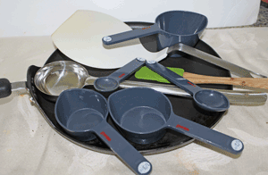 A non-stick pan, large spatula for lifting appau, small spatula to spread oil, a large ladle spoon that is used to scoop the batter, and measuring cups and spoons, handy tools for this recipe