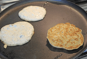 Crumpets cooking in non-stick pan with minimal oil