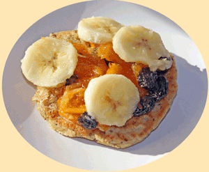 Crumpet topped with fresh and stewed fruit