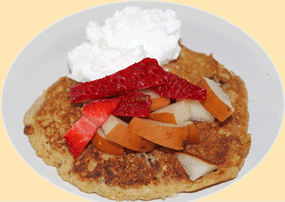 Crumpet topped with fresh fruit and coconut cream which is a vegan cream